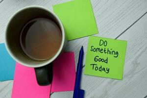 Do Something Good Today write on sticky notes isolated on office desk. photo