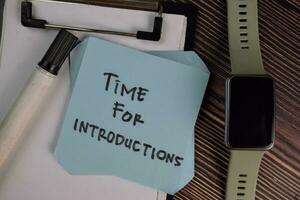 Time for Introductions write on sticky notes isolated on Wooden Table. photo