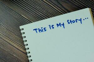 Concept of This is My Story write on a book isolated on Wooden Table. photo