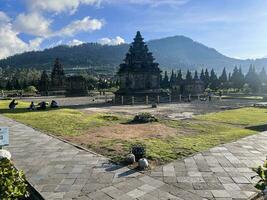 Local tourists visit Arjuna temple complex at Dieng Plateau. Wonosobo, Indonesia photo