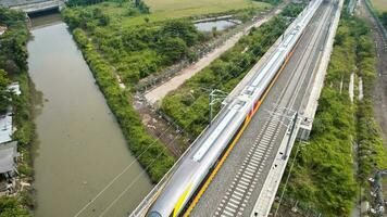 Aerial view of the High speed orange train on the railway station. High Speed Train Jakarta-Bandung. Bandung, Indonesia, November 22, 2022 photo