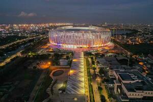 Aerial view of the Beautiful scenery of Jakarta International Stadium. with Jakarta cityscape background. Jakarta, Indonesia, March 8, 2022 photo