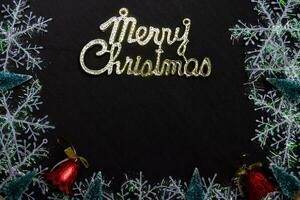 merry christmas text and Decorative Christmas isolated on black background photo