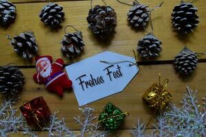 Frohes Fest write on label with wooden backgroud. It means Merry Christmas. Frame of Christmas Decoration. photo