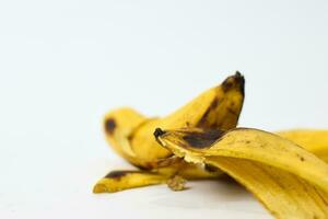 Close up yellow banana peel isolated on white background photo