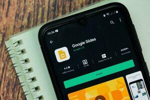 Google Slides dev app with magnifying on Smartphone screen. Google Slides is a freeware web browser developed by Google LLC. BEKASI, WEST JAVA, INDONESIA. NOVEMBER 29, 2020 photo