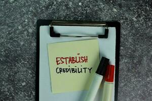 Establish Credibility write on sticky notes on the table. Business concept photo