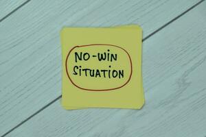 Concept of No-Win Situation write on sticky notes isolated on Wooden Table. photo