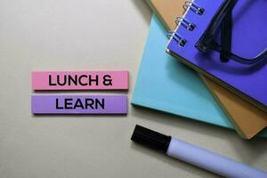 Lunch and Learn text on sticky notes isolated on office desk photo