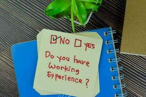 Concept of Do you have working experience No write on sticky notes isolated on Wooden Table. photo