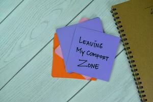 Concept of Leaving My Comfort Zone write on sticky notes isolated on Wooden Table. photo