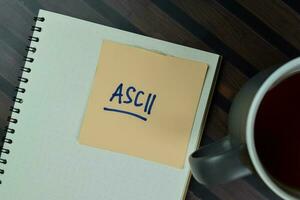 ASCII write on sticky notes isolated on Wooden Table. photo