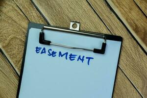 Concept of Easement write on paperwork isolated on Wooden Table. photo