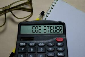Co2 Steuer write on the calculator on Office Desk. German language it means co2 tax photo