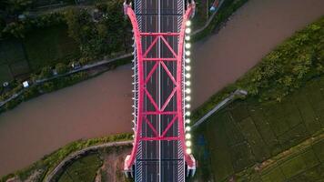 Aerial view of the Kalikuto Bridge, an Iconic Red Bridge at Trans Java Toll Road, Batang when sunrise. Central Java photo