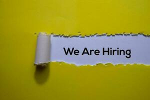 We Are Hiring Text written in torn paper photo
