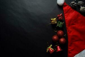 Santa Claus red hat and Decorative Christmas gifts isolated on black background photo