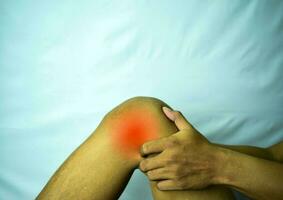 suffering from joint pain with red spot. Hands on leg as hurt from Arthritis. Osteoarthritis knee disease concept photo