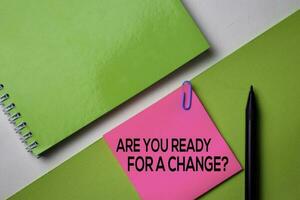 Are You Ready For a Change text on top view office desk table of Business workplace and business objects. photo