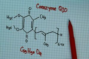 Coenzyme Q10 write on a book. Structural chemical formula. Education concept photo