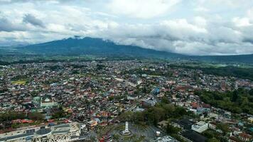 Aerial view of Jam Gadang, a historical and most famous landmark in BukitTinggi City, an icon of the city and the most visited tourist destination by tourists. Bukittinggi, Indonesia, January 25, 2023 photo