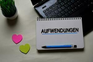 Aufwendungen write on a book isolated on office desk. German Language it means Operating Costs photo