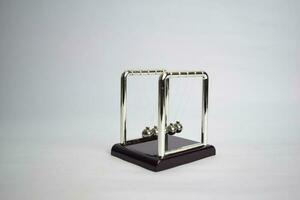 Newton's cradle work. Education, science and physics concept isolated white background photo