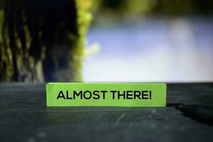 Almost There on the sticky notes with bokeh background photo