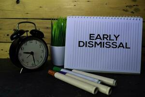 Early Dismissal write on book isolated Wooden background. photo