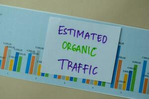 Estimated Organic Traffic write on sticky notes isolated on office desk. photo