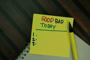 Good Bad Today write on sticky notes isolated on Wooden Table. photo