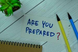 Concept of Are You Prepared write on sticky notes isolated on Wooden Table. photo