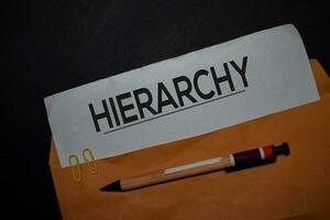 Hierarchy in brown envelope isolated on Office Desk photo