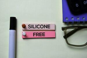 Silicone Free text on sticky notes isolated on office desk photo