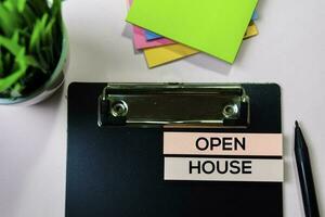 Open House text on sticky notes with office desk concept photo