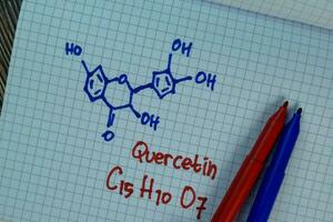 Quercetin write on a book. Structural chemical formula. Education concept photo