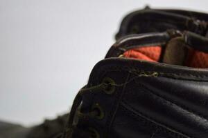 Close up of a brown old boots isolated on white background photo