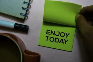 Enjoy Today text on sticky notes isolated on office desk photo