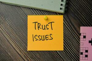 Trust Issues write on sticky notes isolated on office desk. photo