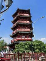 View of pagoda located at Pantjoran Chinatown PIK, surrounded by food stalls, shop and tourist destination. Jakarta, Indonesia, June 23, 2022 photo