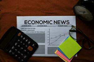 Economic News text in headline isolated on red background. Newspaper concept photo