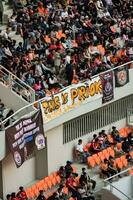 Crowds on Group of fans on the stadium Jakarta International Stadium. Selective focus on banner. Jakarta, Indonesia, August 1, 2022 photo