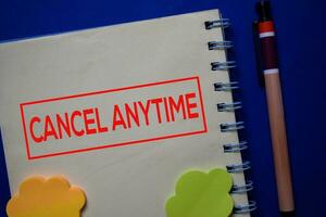 Cancel Anytime write on a book isolated on blue background. photo