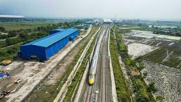 Aerial view of the High speed orange train on the railway station. High Speed Train Jakarta-Bandung. Bandung, Indonesia, November 22, 2022 photo