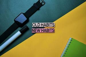 Old Habits or New Habits text on top view color table background. photo