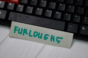 Furloghs write on sticky notes isolated on keyboard computers photo