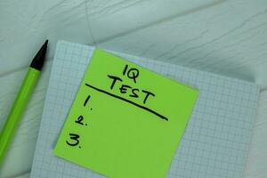 IQ Test write on sticky notes Supported by an additional services isolated on office desk. photo