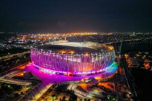 Aerial view of the Beautiful scenery of Jakarta International Stadium. with Jakarta cityscape background. Jakarta, Indonesia, March 8, 2022 photo