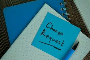 Change Request write on sticky notes isolated on Wooden Table. photo