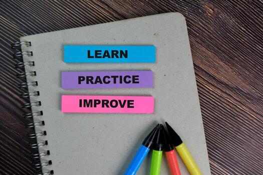 Learn Practice Improve write on sticky notes isolated on Wooden Table. photo